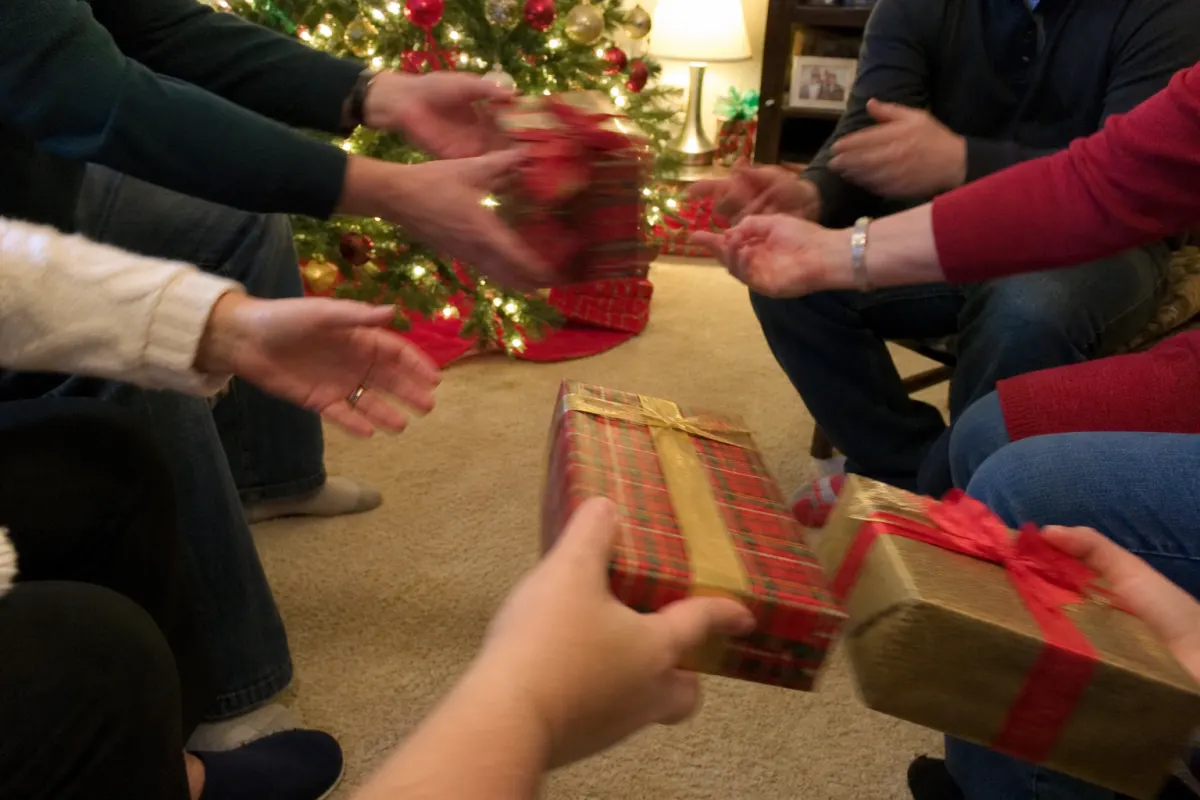 Wrapped gifts being passed around a circle during a Christmas game