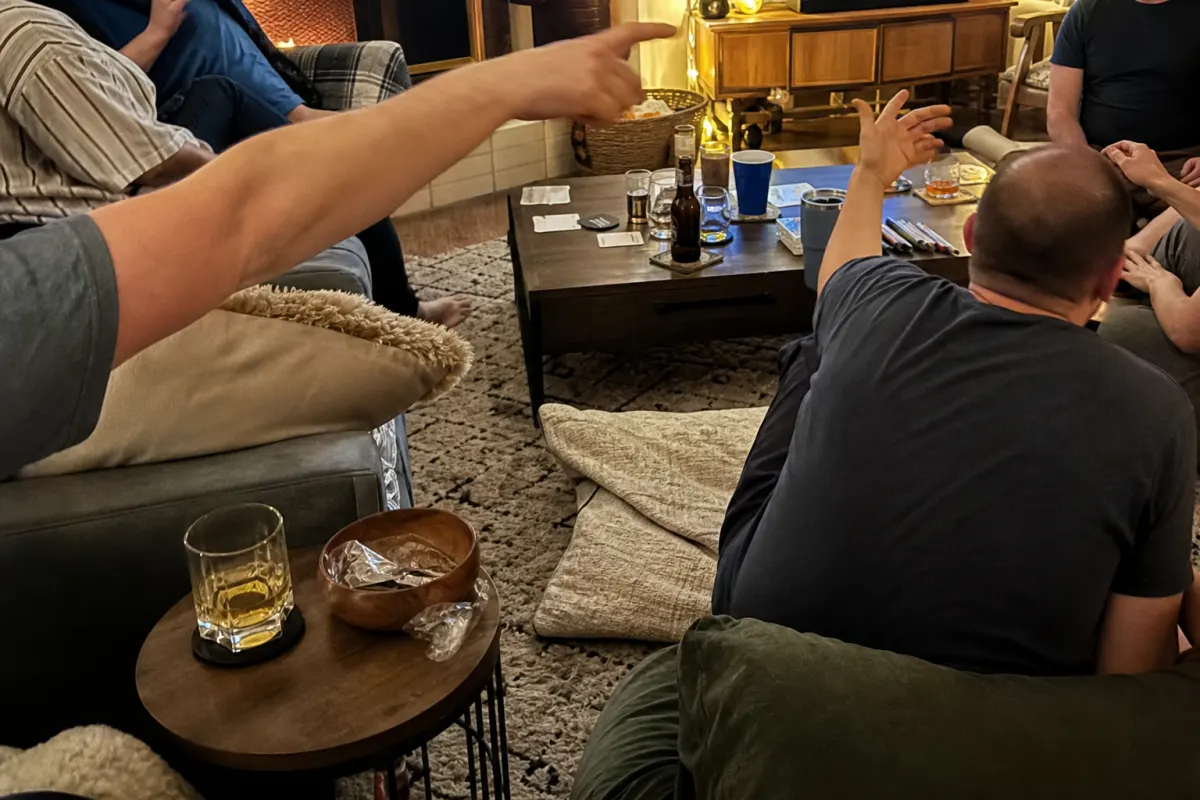 A full living room mid-game at an adult party