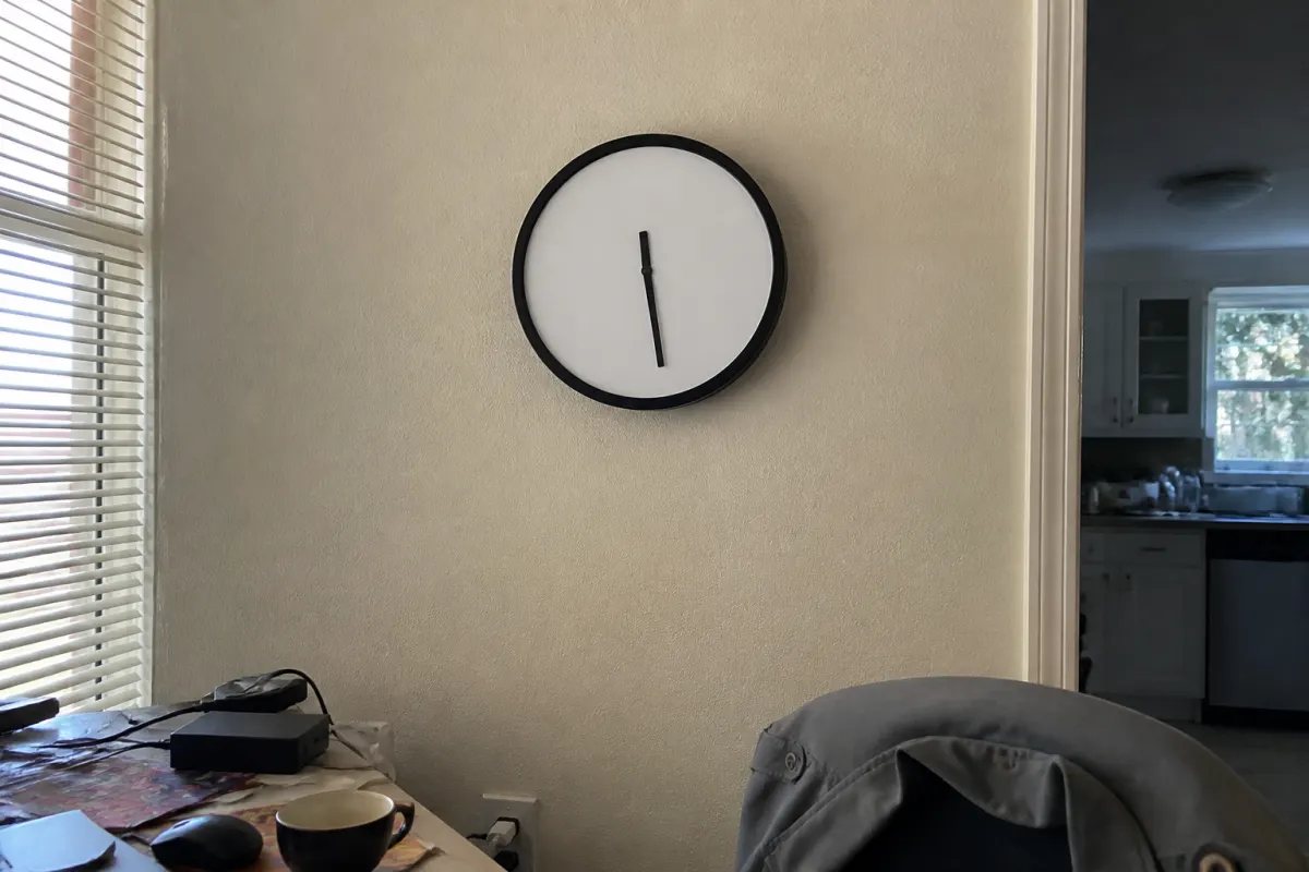 A wall clock with hands but no numbers