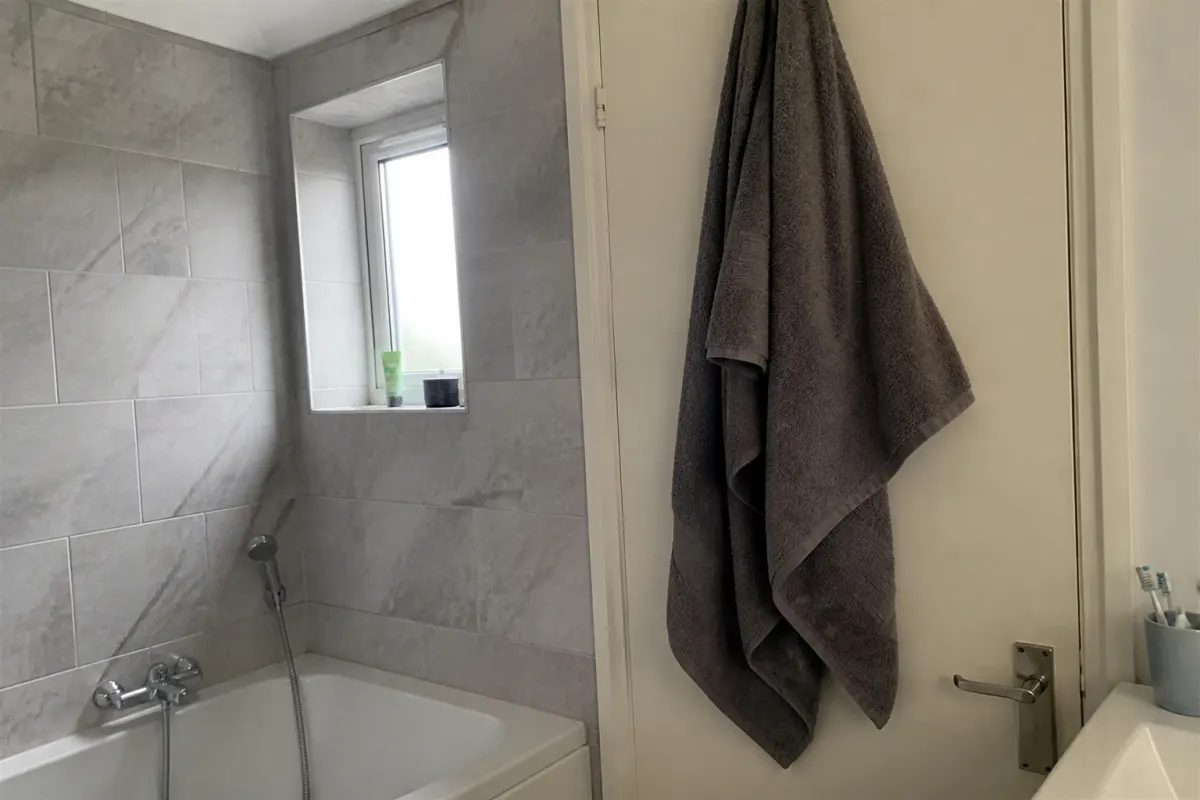 A damp towel hanging on a rail