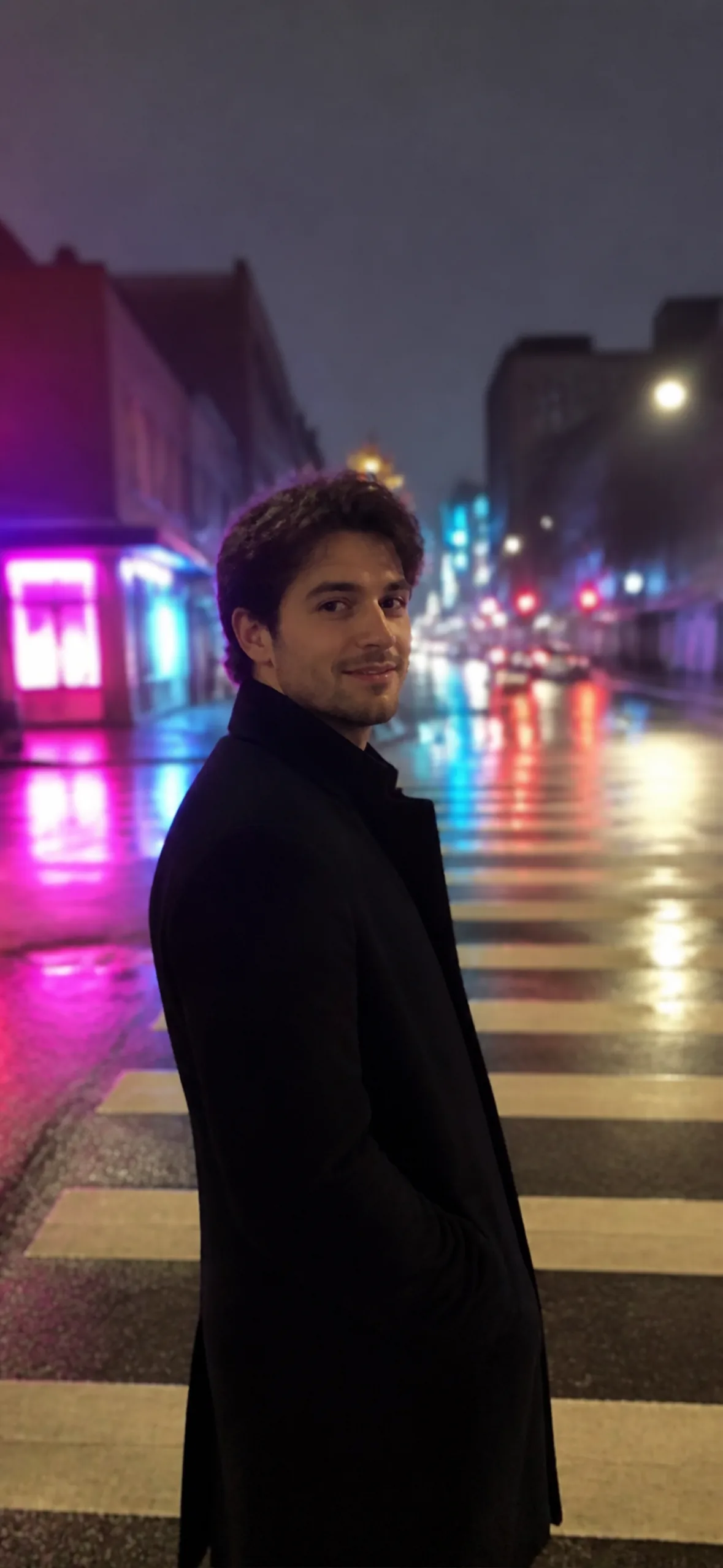 iPhone lock screen wallpaper — man at a neon-lit night crossing