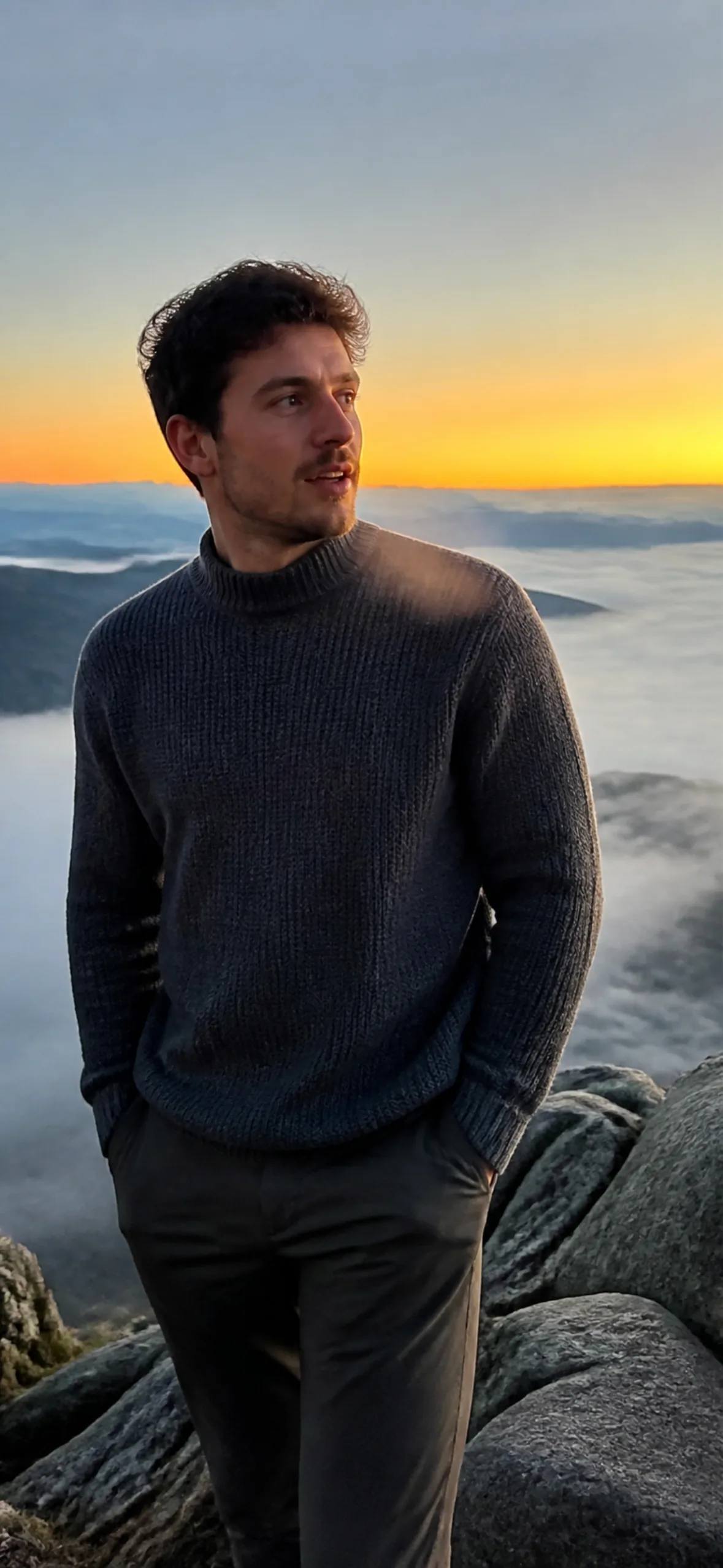 iPhone wallpaper — man on a mountain overlook at first light