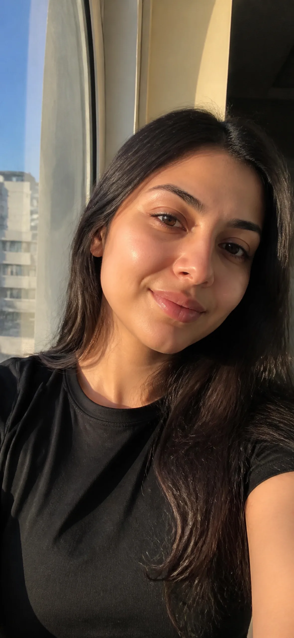 4k phone wallpaper — woman by a window taking a selfie
