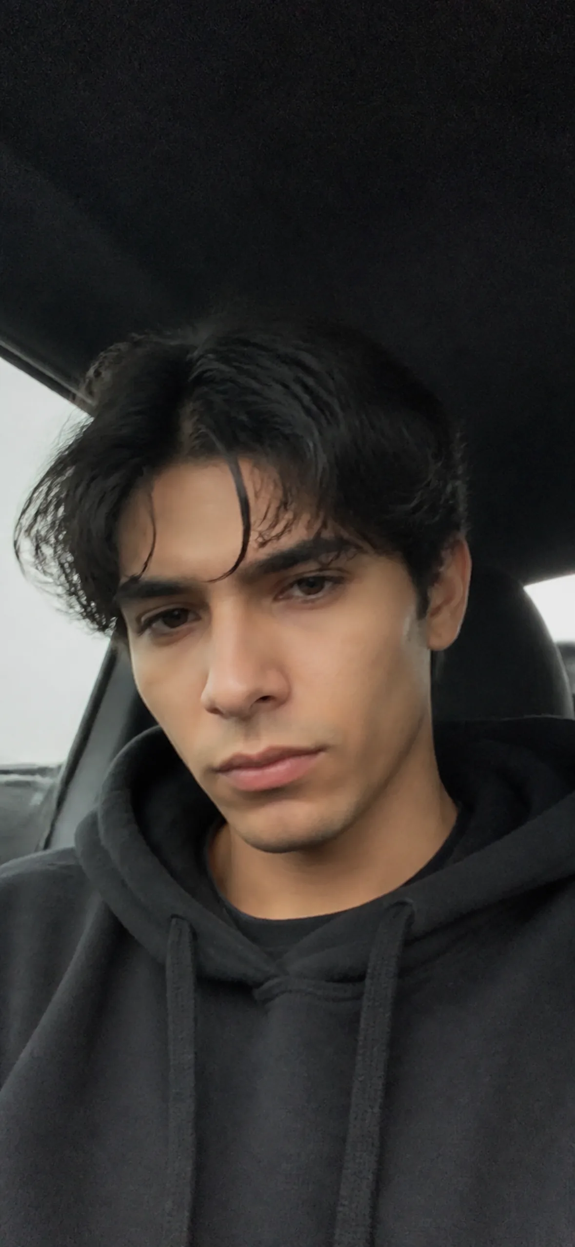 Phone wallpaper — man taking a selfie in a car