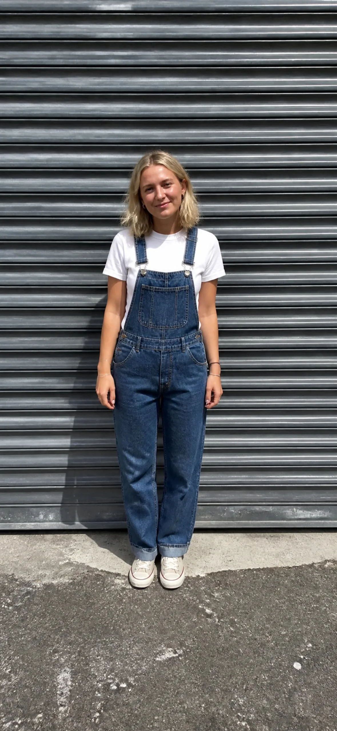 Phone wallpaper — woman in denim against a metal shutter